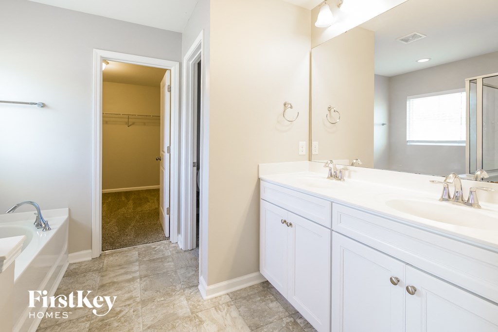 a bathroom with a sink and a mirror and a shower
