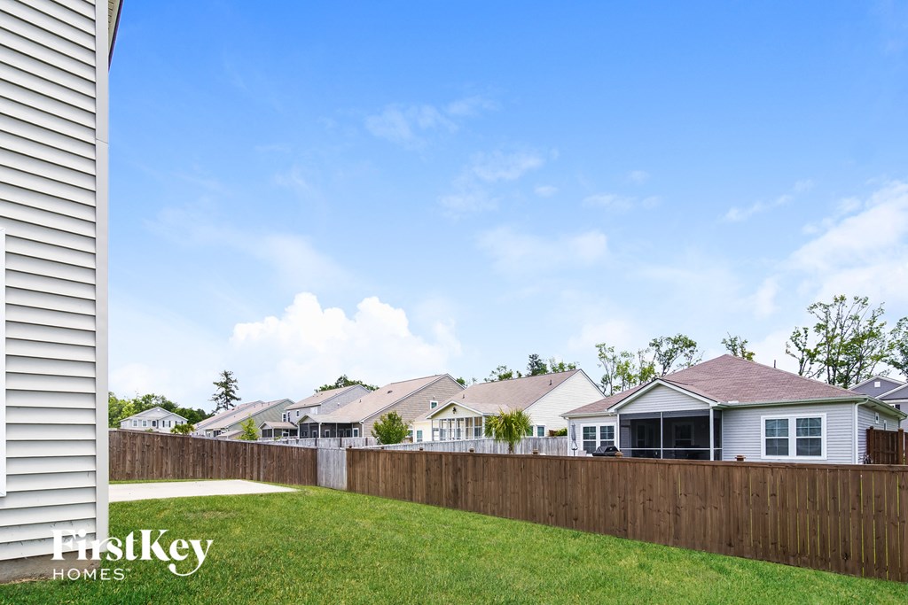 a row of houses behind a wooden fence