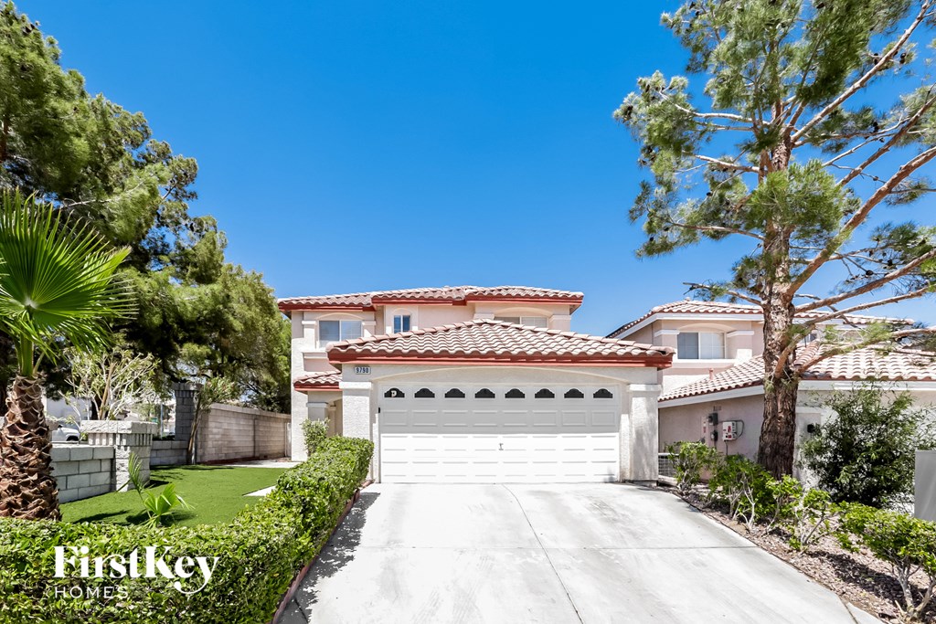 a home with a white garage door and a driveway