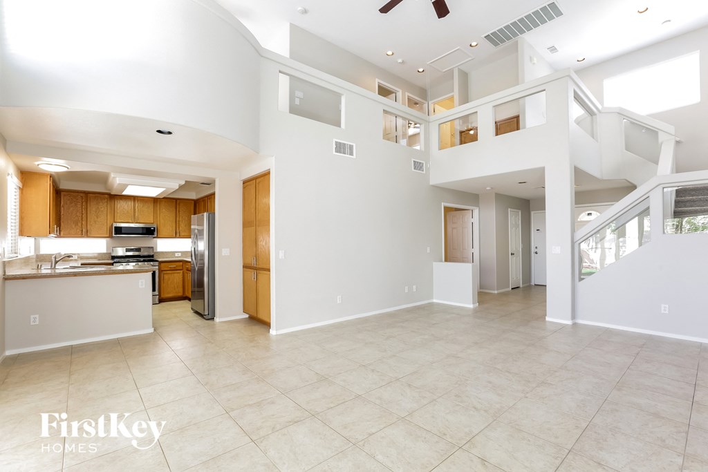 a large open kitchen and living room with a staircase