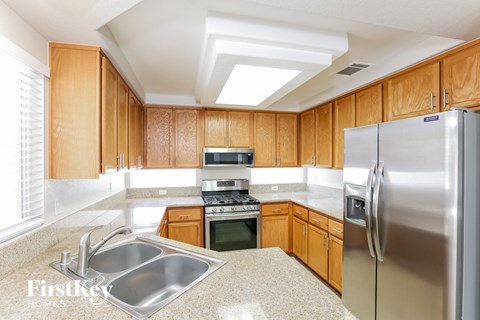 a kitchen with wooden cabinets and stainless steel appliances