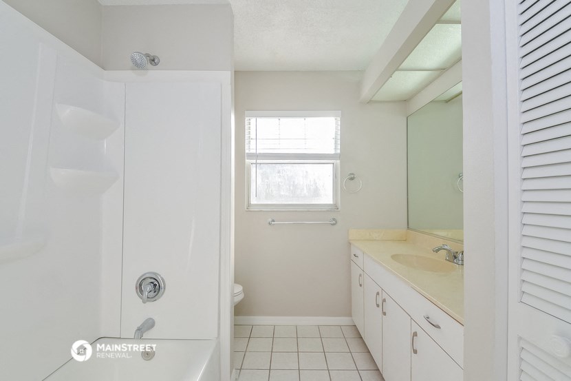 a bathroom with a shower and a sink and a toilet