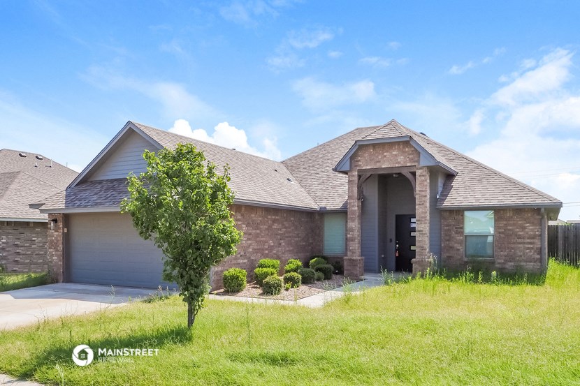 a house with a roof and a tree in front of it