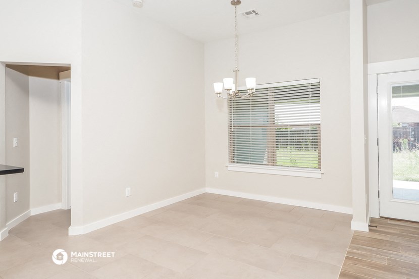 the living room and dining room of a renovated house