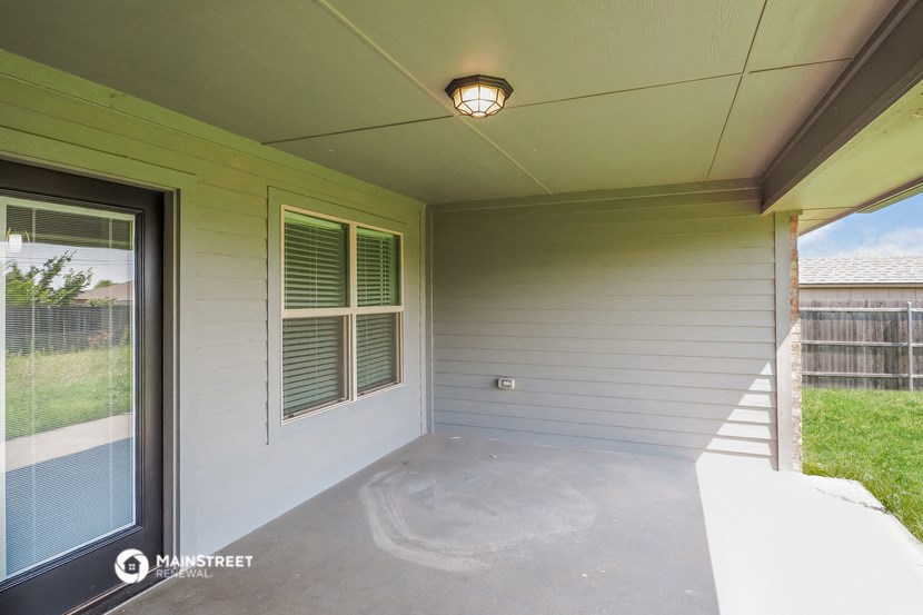 the screened porch of a manufactured home with a large window