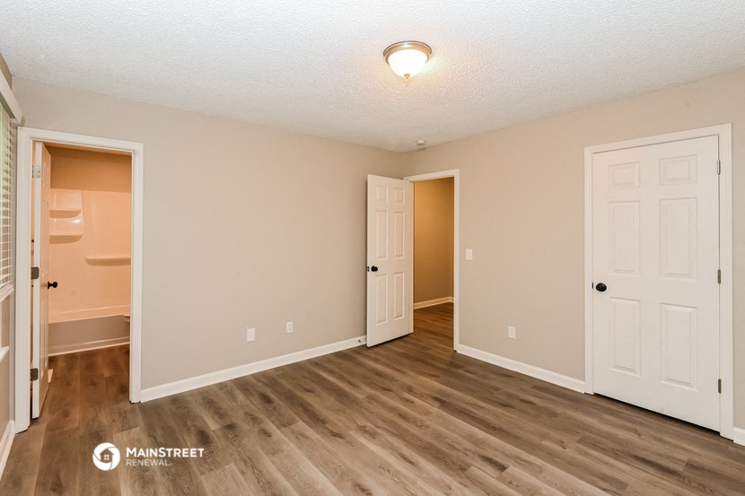 the spacious living room and bathroom of a 560 sq ft home