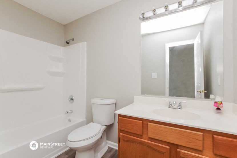 a bathroom with a toilet and a sink and a mirror