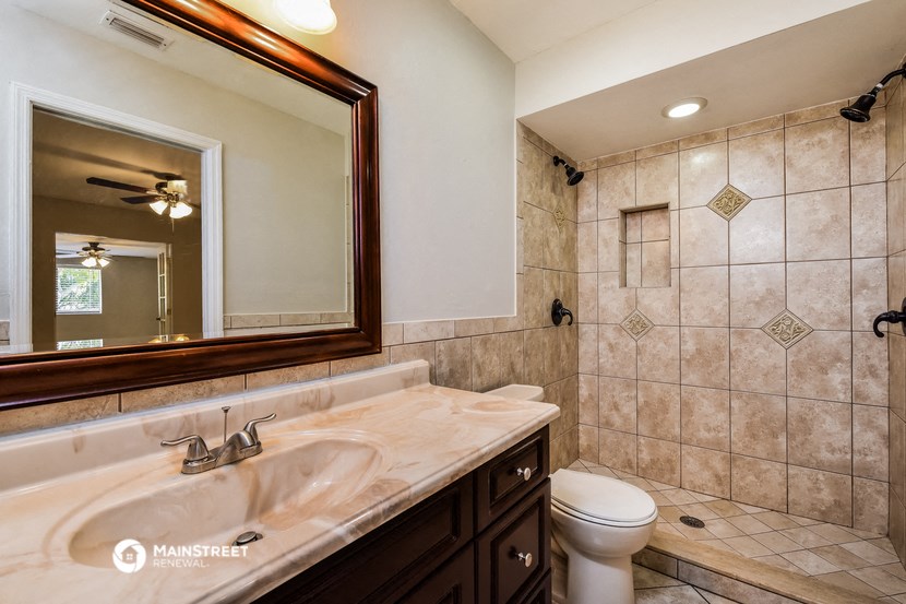 the master ensuite bathroom has a large mirror and a shower