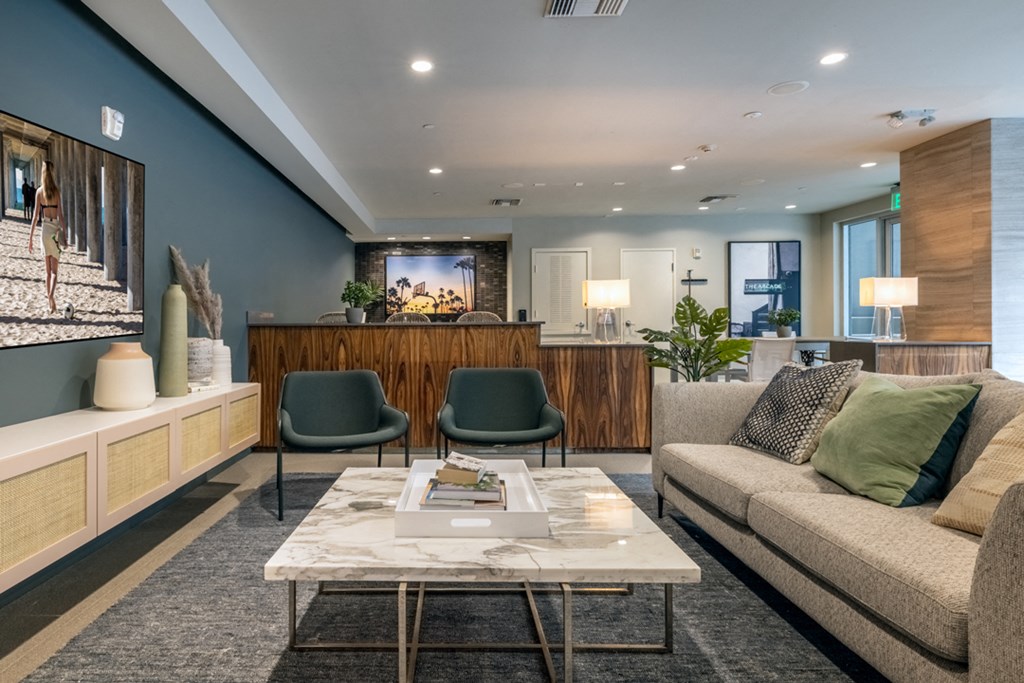 a lobby with a couch and chairs and a coffee table