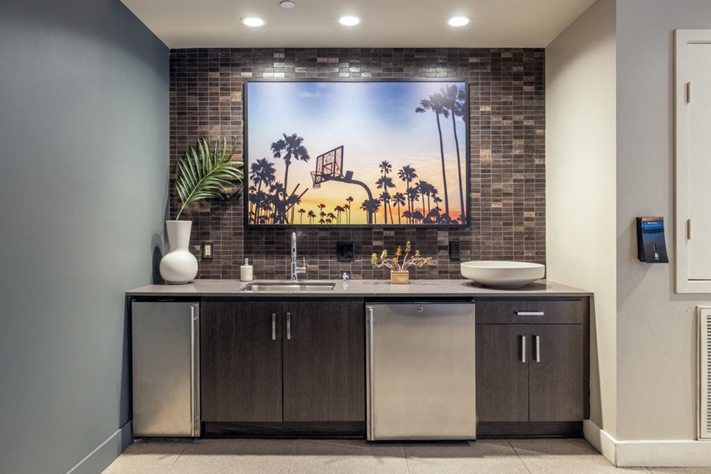 a bathroom with a sink and a tv on the wall