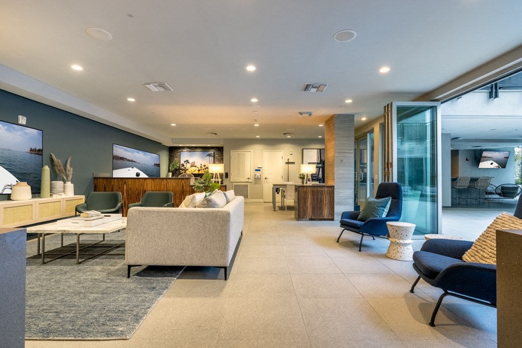 a living room with a couch and chairs and a table