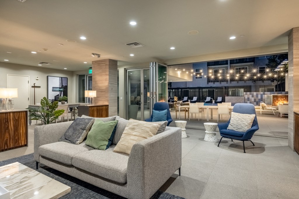 a living room with a couch and chairs in a house