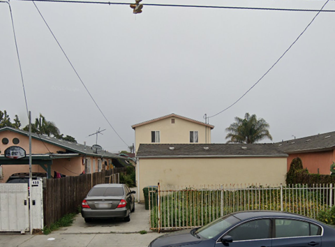 a house with two cars parked in front of it