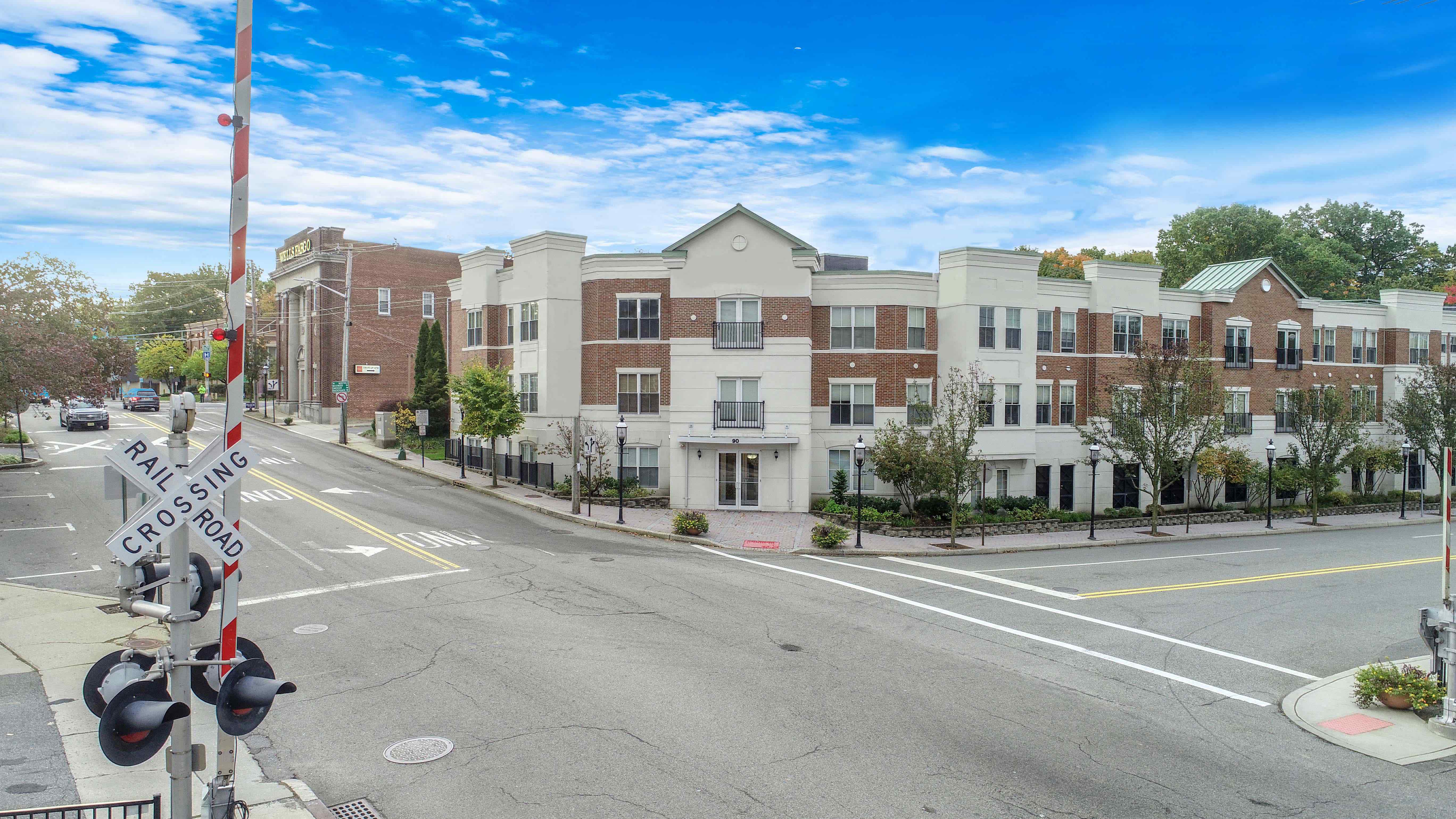 a view of an empty street in front of an apartment building