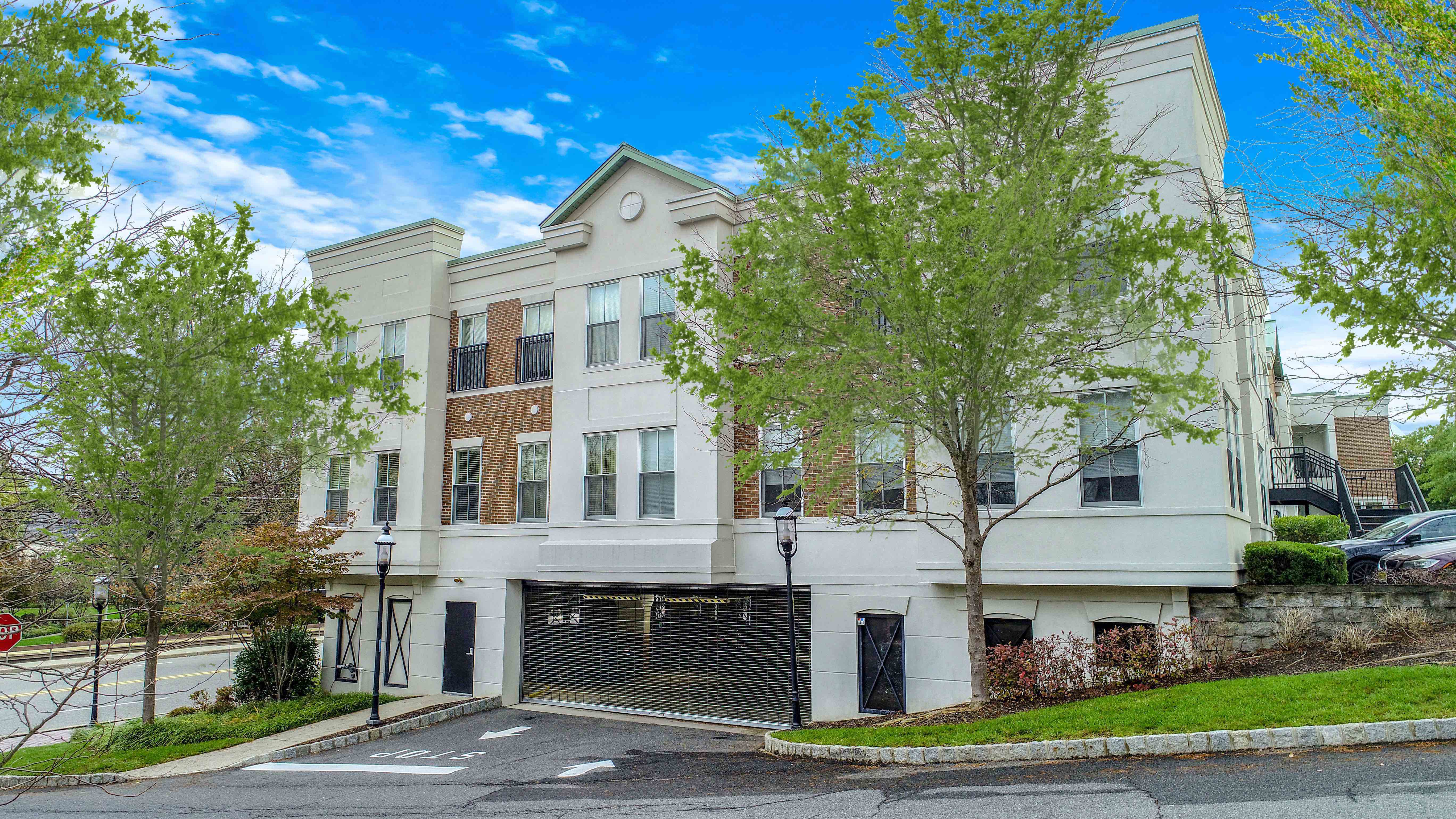 a white and brick building with a garage door