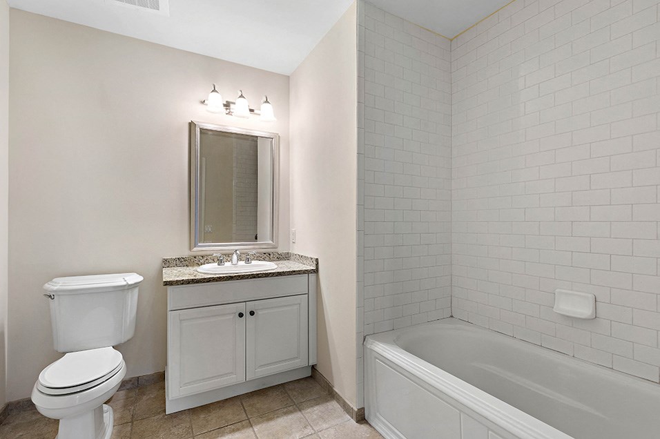a bathroom with a sink toilet and a bath tub