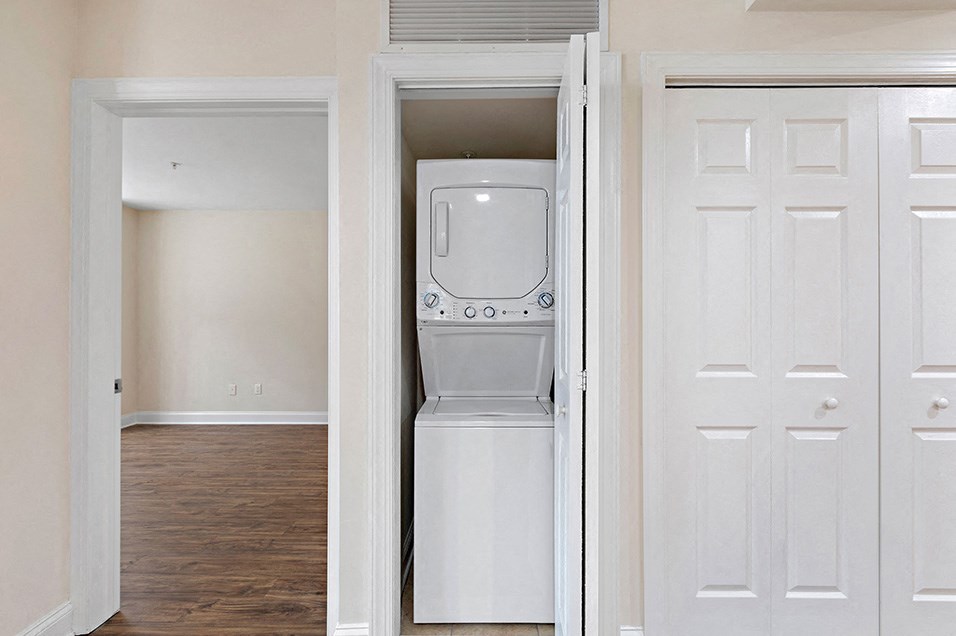 an empty laundry room with a washer and dryer in it