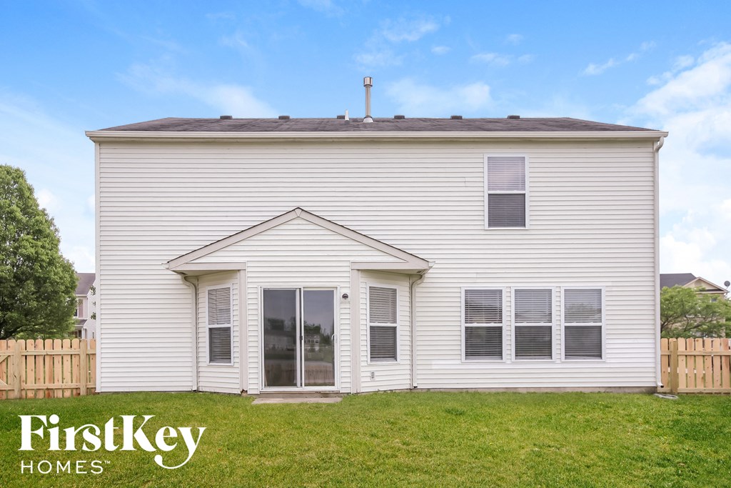 a small white house with a lawn in front of it