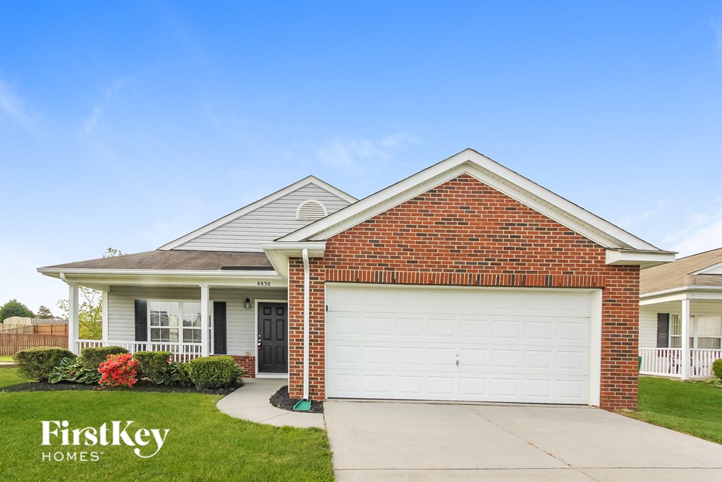 a brick house with a white garage door