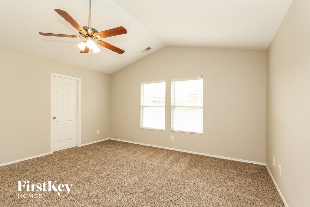 the master bedroom is spacious and has a ceiling fan