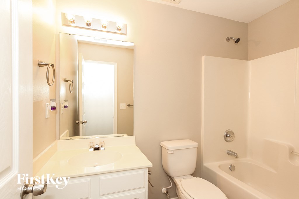 a bathroom with a sink toilet and a bath tub