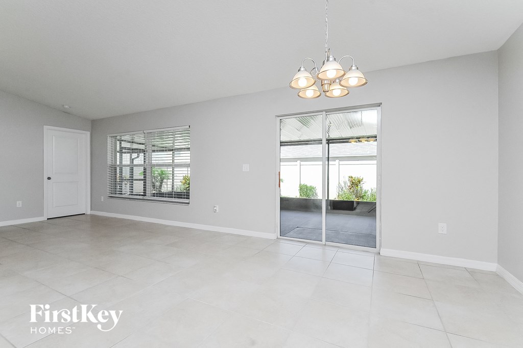 an empty living room with a door to a patio