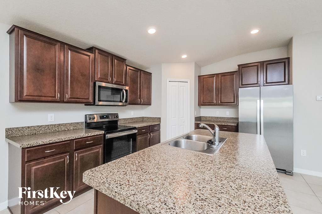 a kitchen with a granite counter top and a sink