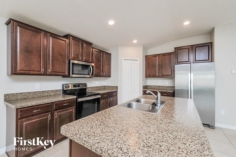 a kitchen with a granite counter top and a sink