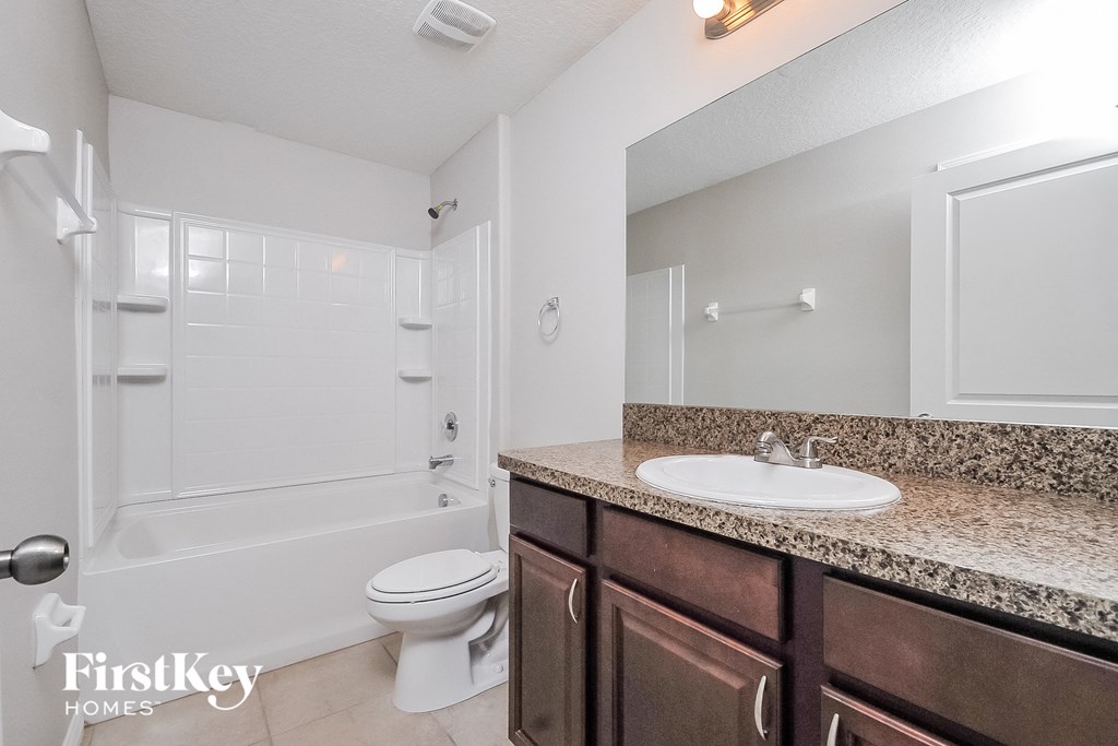a bathroom with a sink and a toilet and a shower