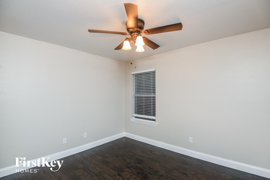 a living room with a ceiling fan and a window