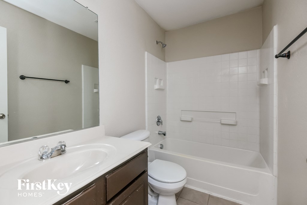 a bathroom with a sink and a toilet and a bath tub