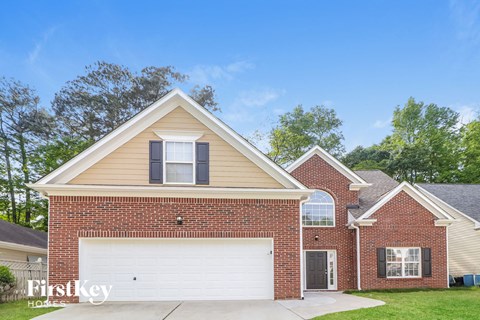 a brick house with a white garage door