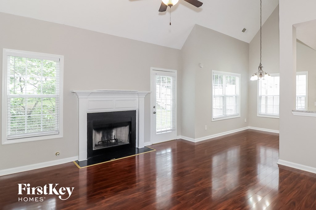 a living room with a fireplace and a wooden floor