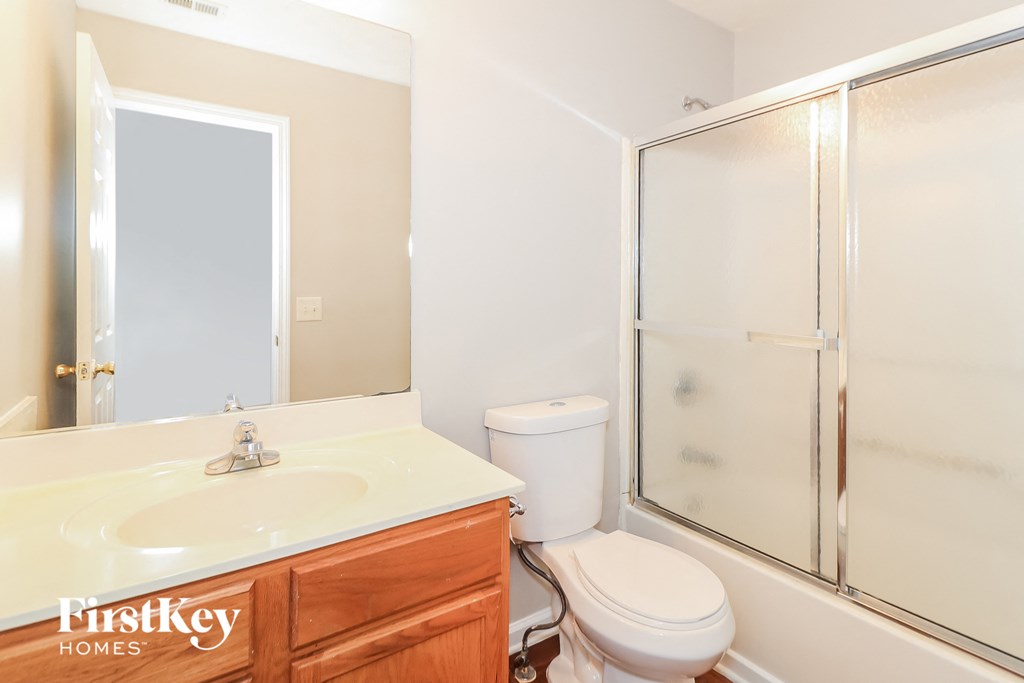 a bathroom with a sink toilet and a shower