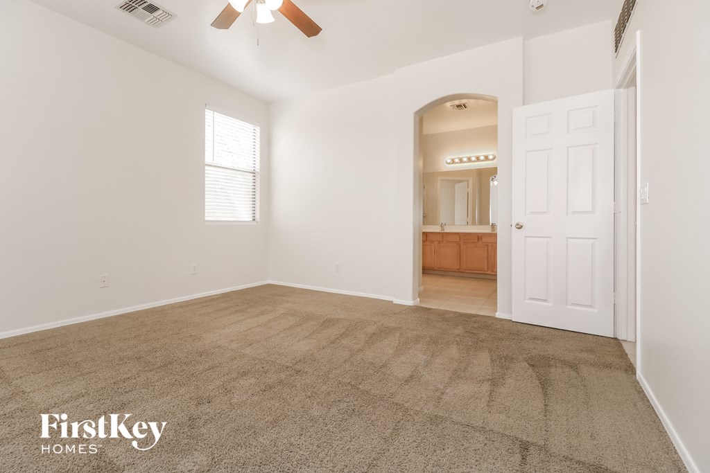 an empty living room with carpet and a white door