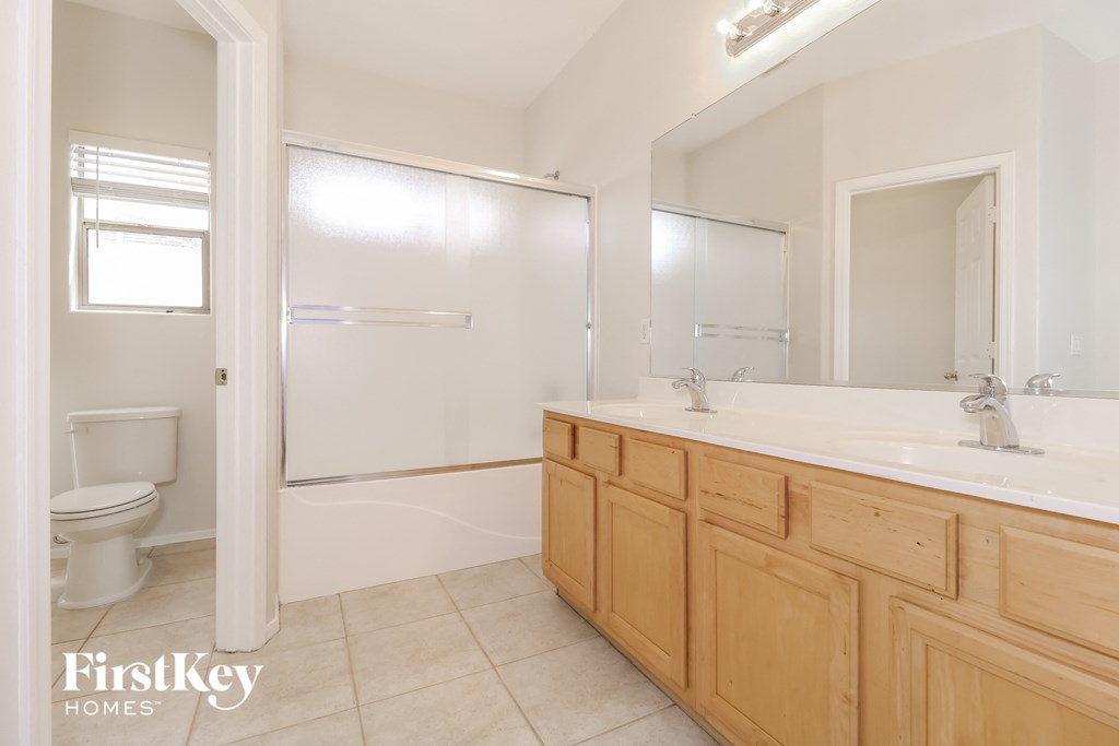 a bathroom with a sink and a shower and a toilet