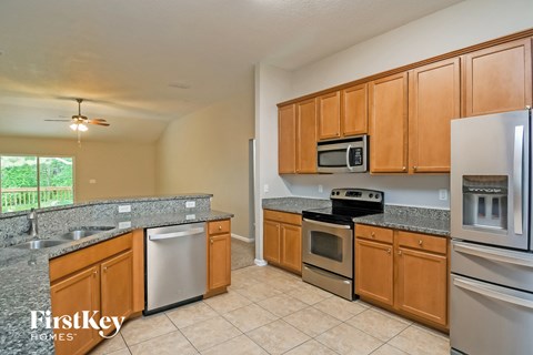 A kitchen with wooden cabinets and stainless steel appliances.