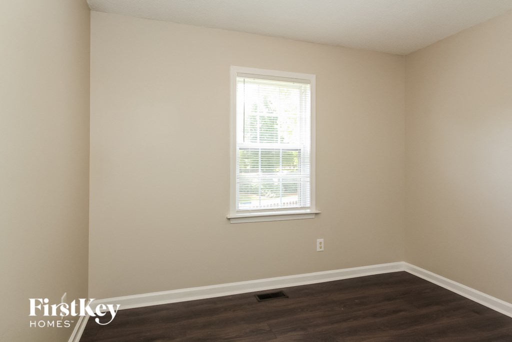 a room with a window and a wooden floor