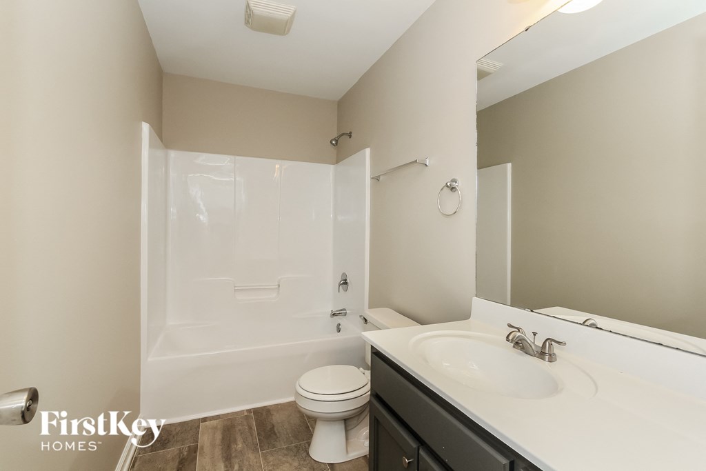 a bathroom with a sink and a toilet and a shower
