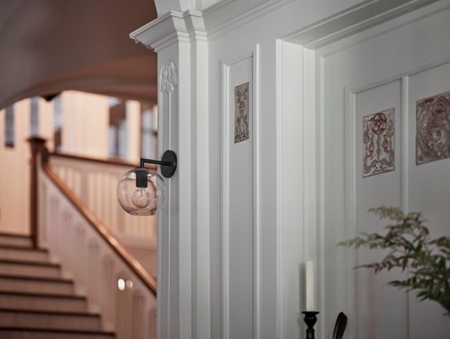 A staircase with a light bulb hanging from the banister.