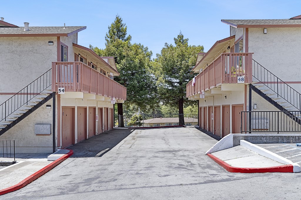 an empty parking lot in front of an apartment building