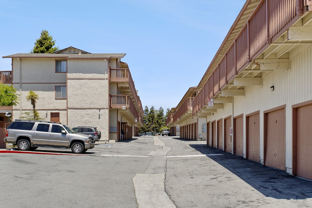 a city street with cars parked in front of buildings