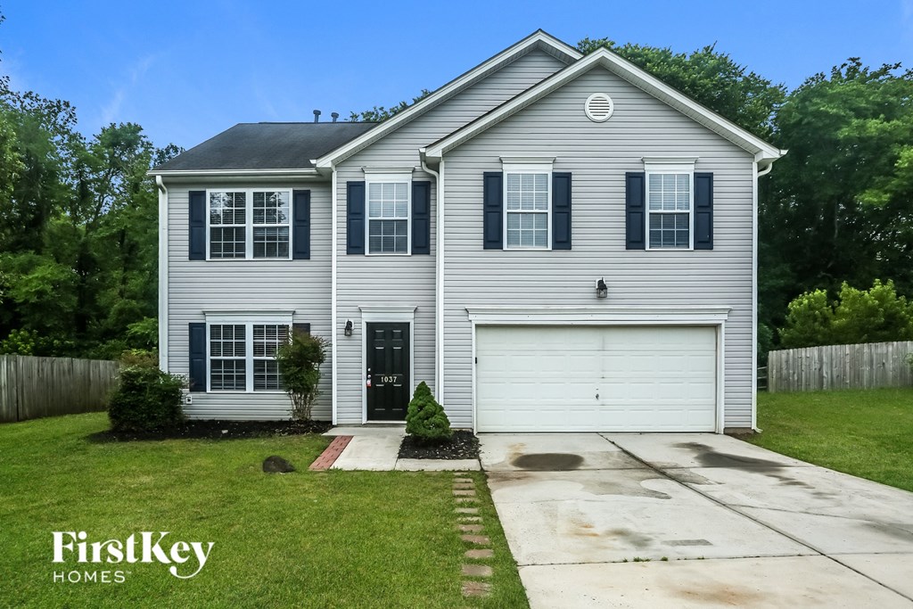 a white house with black shutters and a white garage door