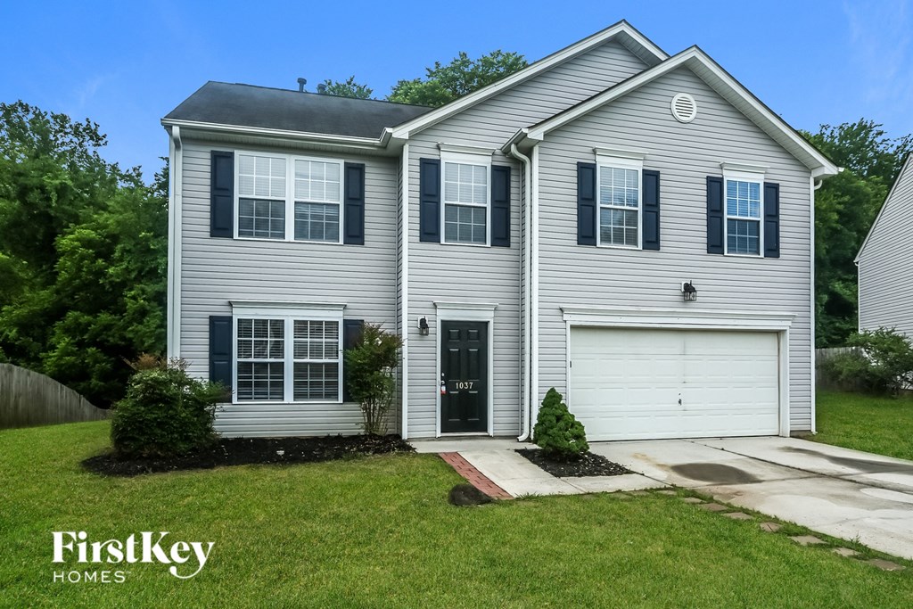 a white house with black shutters and a black garage door