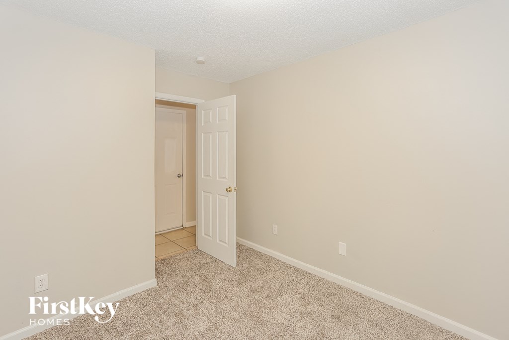 a bedroom with a door and a door to a closet