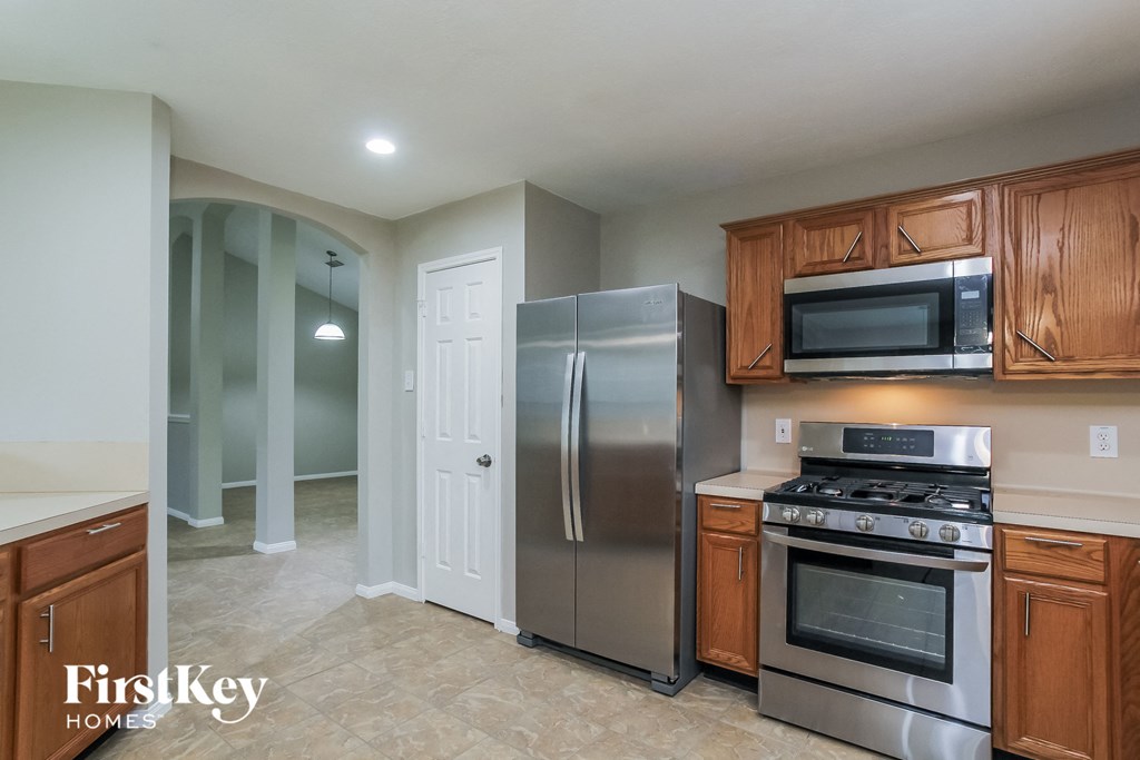 a kitchen with stainless steel appliances and wooden cabinets