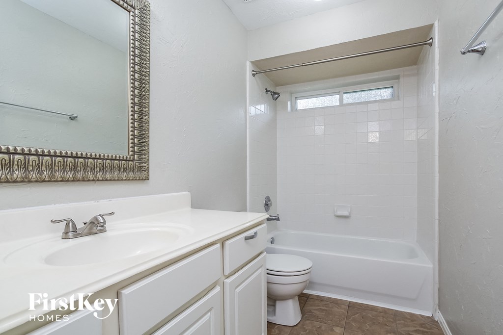 a bathroom with a sink toilet and a bath tub
