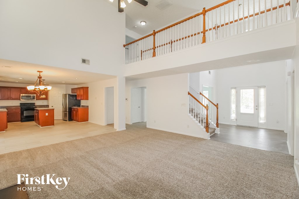 the spacious living room and kitchen in this home for sale