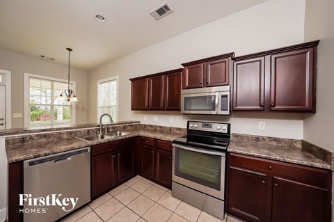 a kitchen with granite counter tops and stainless steel appliances