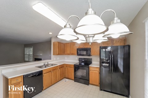 a kitchen with black appliances and wooden cabinets